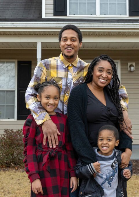 TUESDSAY, DECEMBER 7, 2021 - GRIFFIN, GA - Nicole Howson and her family stand in front of their home in Griffin, Ga. L-R Clockwise Latroun Epps, Nicole, Talysa Epps and Israel Epps. Lynsey Weatherspoon for NPR